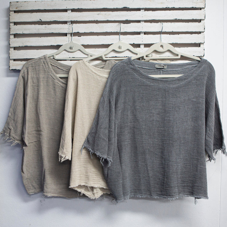 Natural woven linen top with round neck and 3/4 sleeves with frayed detail