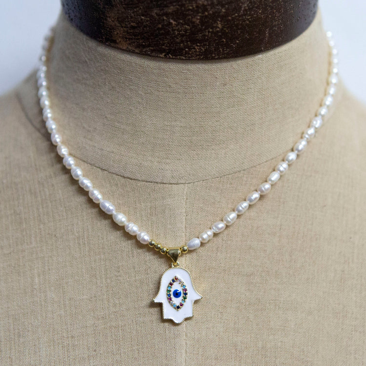 Pearl necklace with white and gold hand charm