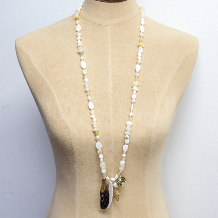 Natural tones long necklace with crystal pearl and gold and feather charms