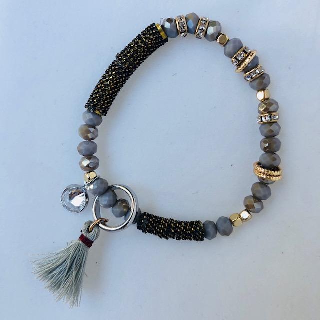 Grey crystal bracelet with rose gold diamante and grey tassels and charms