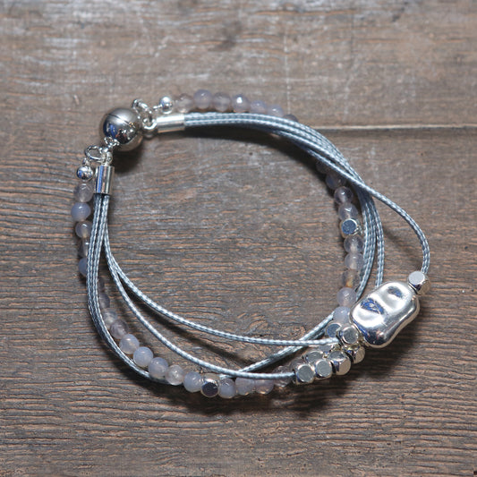 Layered rope bracelet with natural stone and silver charms